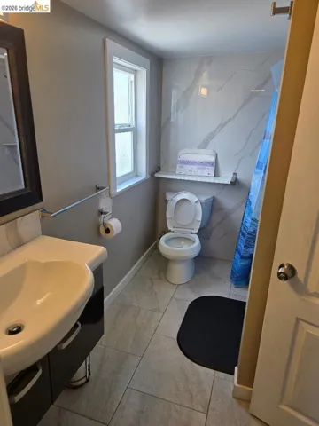 Full bath featuring vanity and a shower with curtain