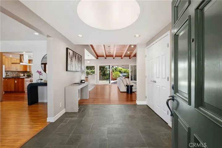 LET'S GO IN...FORMAL ENTRYWAY.  DIRECTLY IN FRONT OF YOU IS THE FAMILY ROOM WITH DOUBLE SLIDERS EXTENDING OUT TO COURTYARD WITH JACUZZI.  NOTICE TO THE LEFT IS THE LIVING ROOM WITH ENTRY INTO GOURMET KITCHEN.