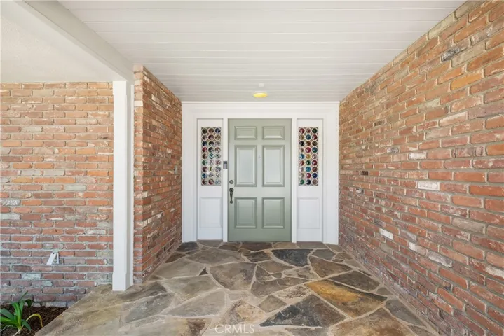 FRONT DOOR.  NOTICE BRICK WALLS AND SLATE FLAGSTONE WELCOMING YOU, FRIENDS AND FAMIY TO THIS BEAUTIFUL PROPERTY.