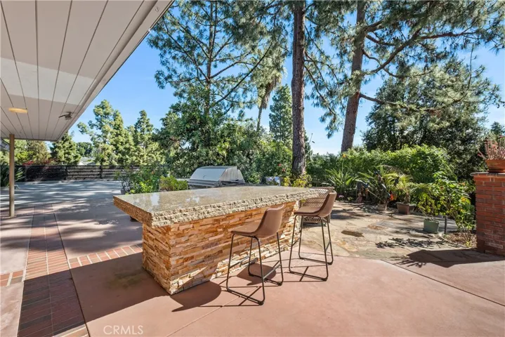 OUTDOOR ENTERTAINING AREA WITH HUGE GRANITE SLAB OVER STACKED BASE TO ENTERTAIN AND SERVE FRIENDS AND FAMILY OUTDOORS. OR PERFECT AS A GAME TABLE.