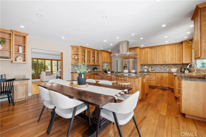 GOURMET KITCHEN INCLUDES A BUILT-IN DESK AND SEPARATE DINING AREA.  NOTICE WIDE OPENING LEADING TO FORMAL LIVING ROOM.