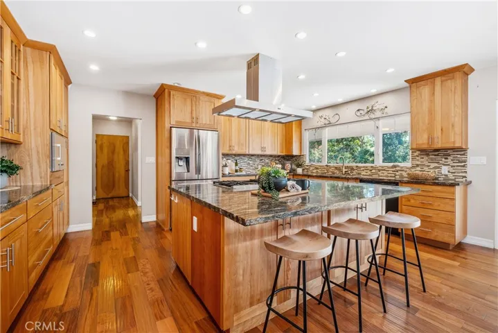 DIFFERENT VIEW OF KITCHEN.  NOTICE ENTRY TO THE HALLWAY JUST PAST THE KITCHEN LEADING TO 3 CAR GARAGE, LAUNDRY ROOM, WALK-IN PANTRY AND POWDER ROOM.