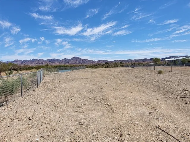 Property viewed from gate, fenced on both sides