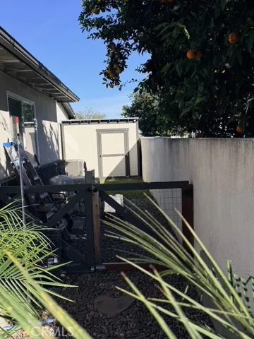 Fenced side yard with storage shed