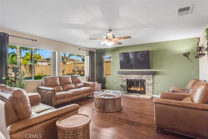 Anchored by a stone fireplace, it’s the kind of space where movie nights, holiday mornings, and everyday moments naturally come together. Large windows continue the theme of natural light, while the open flow to the kitchen keeps everyone connected, whether you’re hosting a full house or enjoying a quiet evening in.