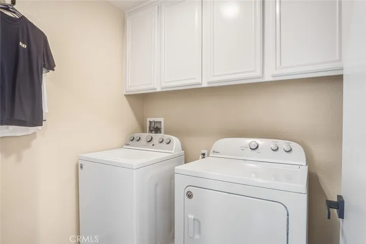 Tucked conveniently away on this level, the utility room is designed with practicality in mind. Built-in cabinets provide generous storage for laundry essentials and household items.