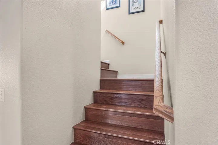 Head upstairs via the wood staircase to a spacious primary suite tucked quietly at the end of the hall.