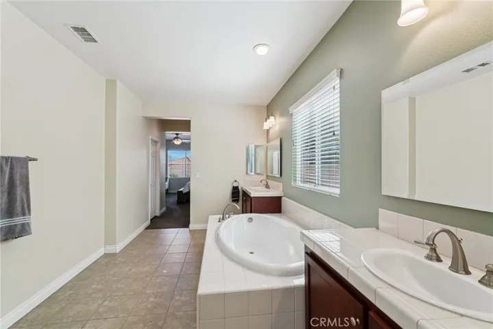 Primary bathroom with dual sinks and a large soaking tub
