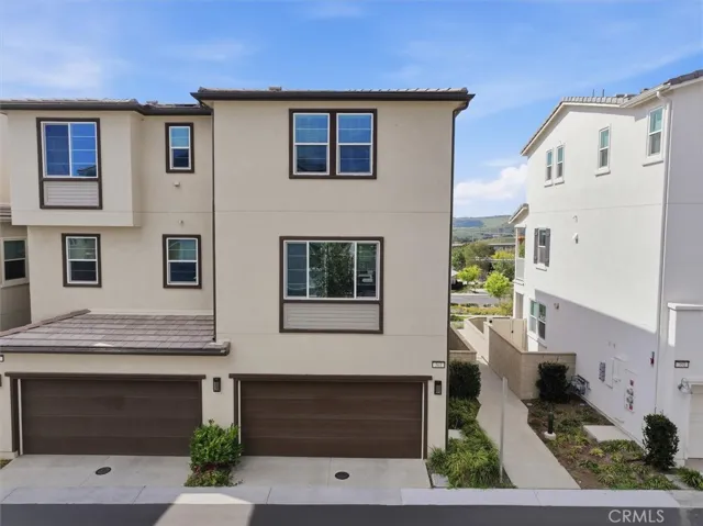 Back of the home with two-car garage