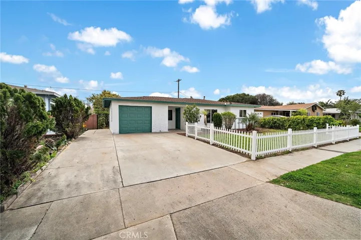 Adorable Curb Appeal with White Picket Fence Surrounding Lush Front Yard