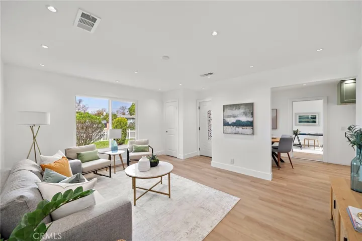 From the moment you arrive, the home’s inviting curb appeal welcomes you with a lush grassy lawn, colorful gardens, charming white picket fence, and a tiled covered entry.