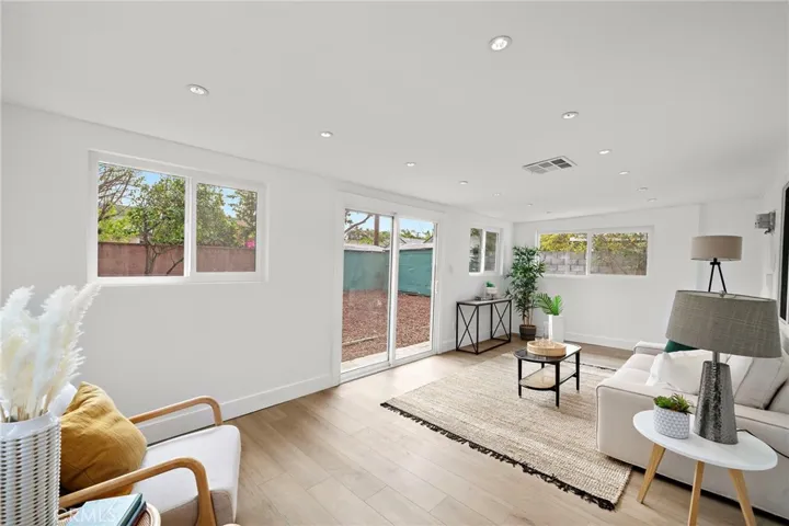 New! New! New! featuring brand new wood-vinyl flooring throughout, new dual pane windows and sliding glass door, new raised panel interior doors, new mirrored closet doors, fresh interior paint, recessed lighting in every room, and brand new central A/C.