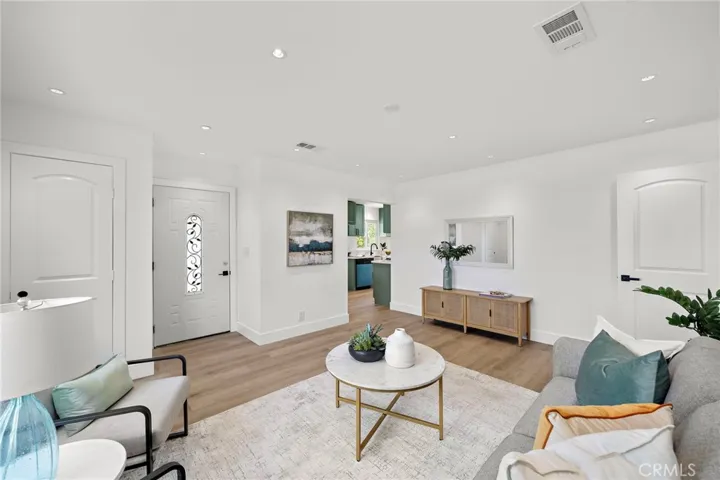 New! New! New! featuring brand new wood-vinyl flooring throughout, new dual pane windows and sliding glass door, new raised panel interior doors, new mirrored closet doors, fresh interior paint, recessed lighting in every room, and brand new central A/C.