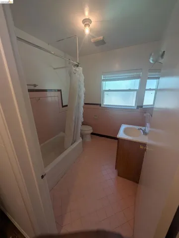 Bathroom featuring vanity and shower / bath combo with shower curtain