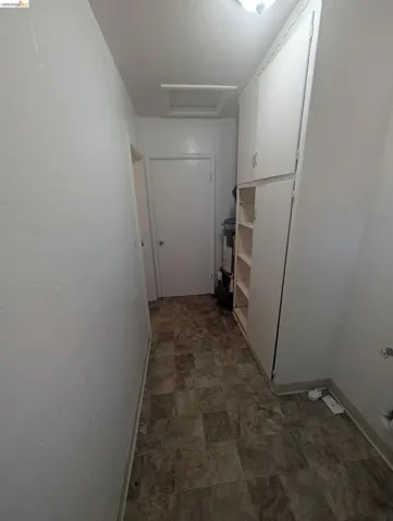 Hall with attic access and stone finish flooring