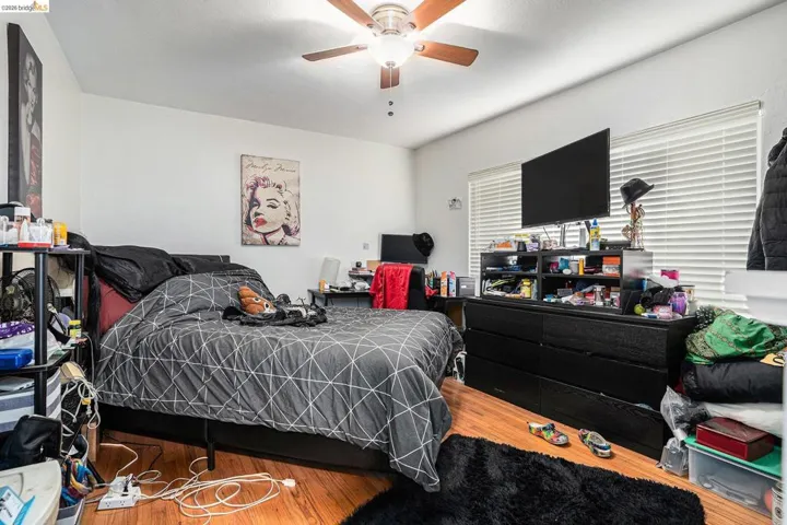 Bedroom featuring wood finished floors and a ceiling fan
