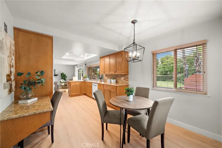 double pantries, deep pots & pans drawers, lazy Susan, and hidden recycle/trash, along with a gas cooktop, double ovens, microwave, dishwasher, and coffered ceiling w/recessed lighting