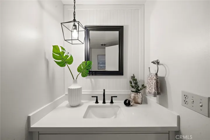 The main level also includes a beautifully remodeled half bath with wainscoting, a convenient inside laundry room, and direct access to the 3-car garage.