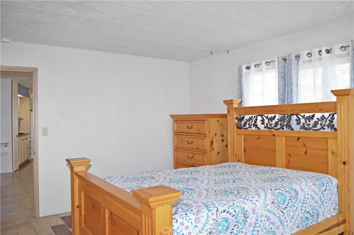 Spacious main bedroom suite with custom tile floor and garden window (bed and dresser are included)