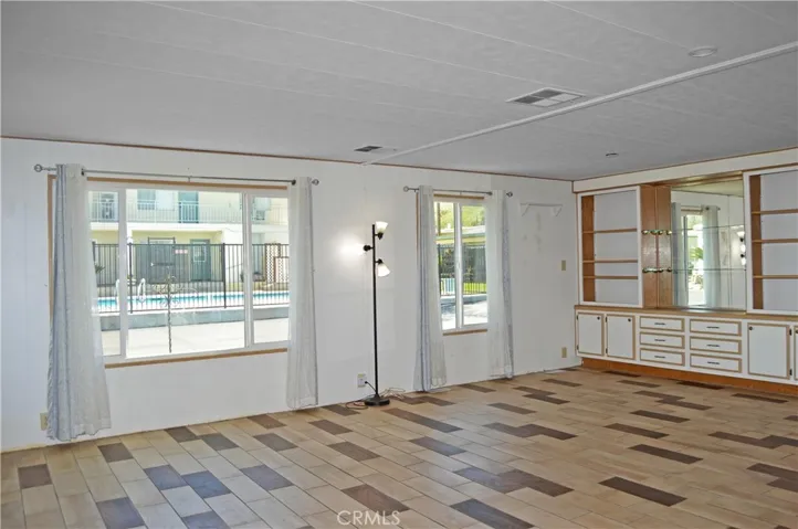 Custom tile and dual-paned windows and built-in hutch in this living room/dining room combination