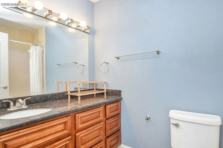 Full bath with vanity and a shower with shower curtain