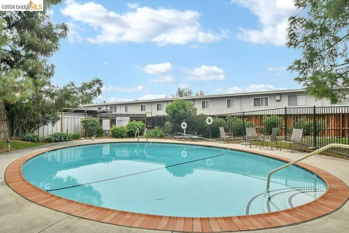 Community pool featuring a patio area