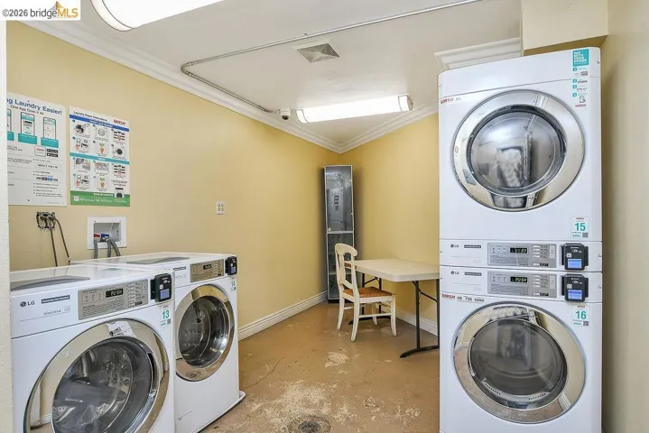 Shared laundry with crown molding and stacked washing machine and dryer