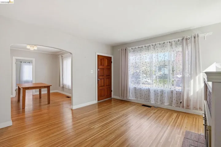 Foyer entrance with light wood-style floors, plenty of natural light, and arched walkways