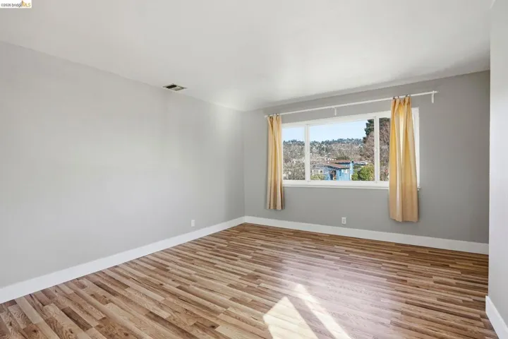 Empty room with light wood-style floors and baseboards