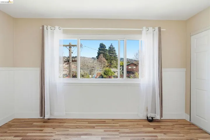 Unfurnished room with wainscoting and light wood-type flooring