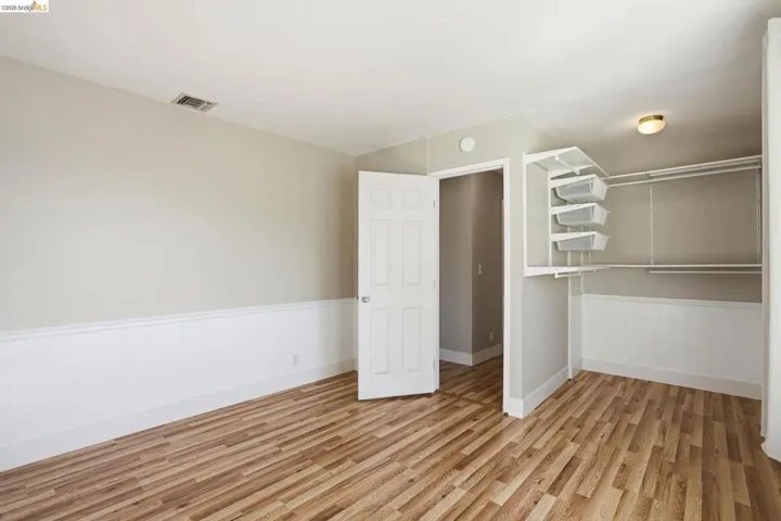 Unfurnished bedroom featuring light wood-style floors and a closet