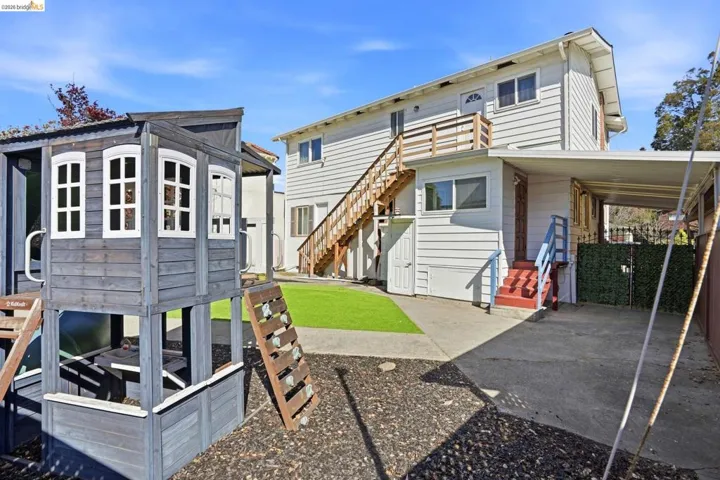 Rear view of house featuring stairway
