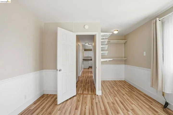 Spare room with a wainscoted wall and light wood finished floors