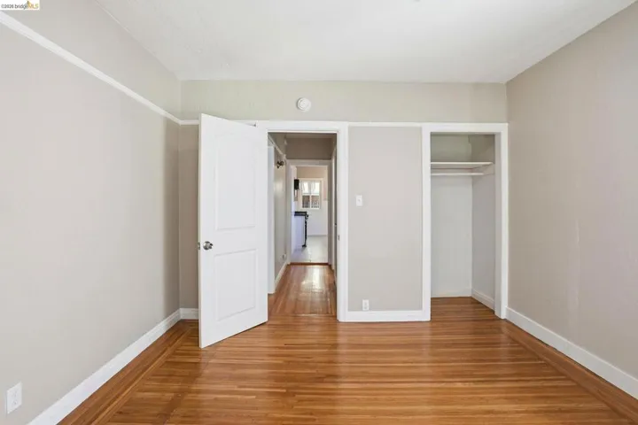 Unfurnished bedroom featuring wood finished floors and a closet