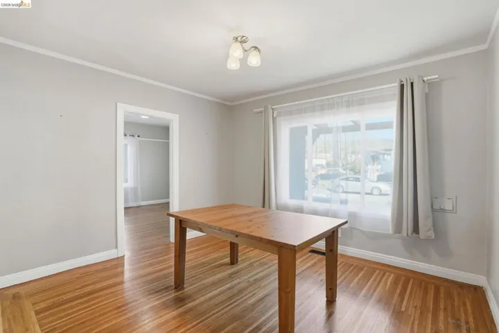 Dining area featuring crown molding and light wood-type flooring