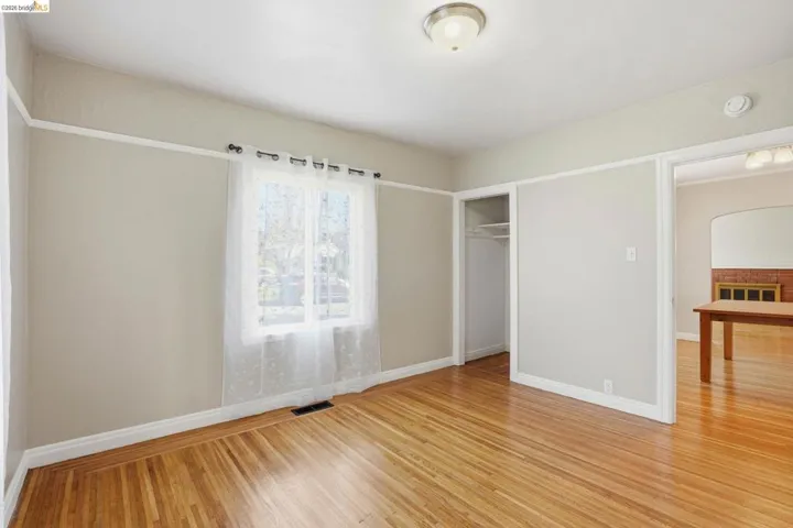 Unfurnished bedroom featuring light wood finished floors and a closet