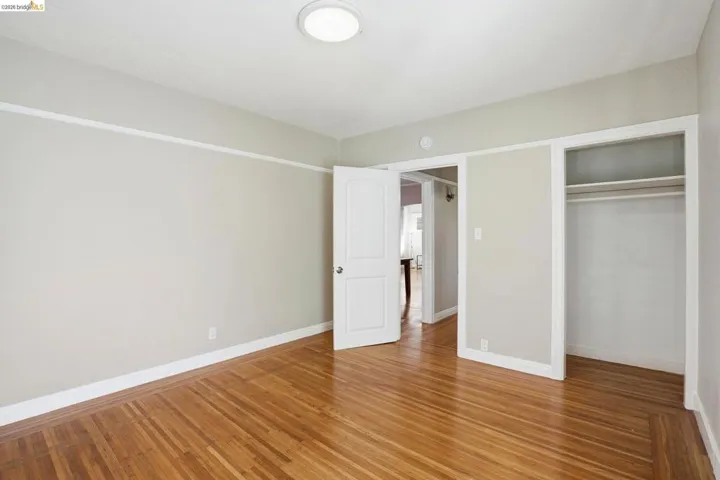 Unfurnished bedroom with light wood-style flooring and a closet