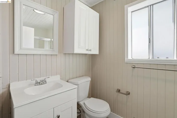 Bathroom with vanity and wooden walls