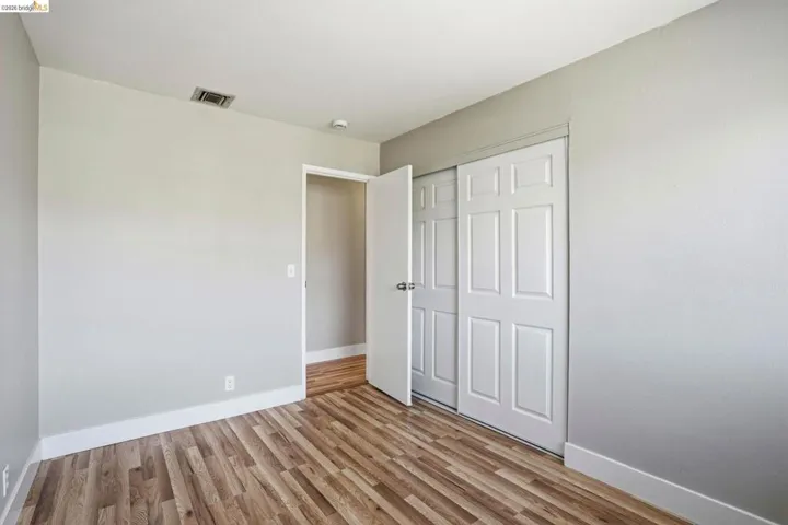 Unfurnished bedroom featuring light wood-type flooring and a closet