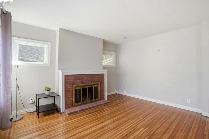 Unfurnished living room featuring light wood-type flooring and a fireplace