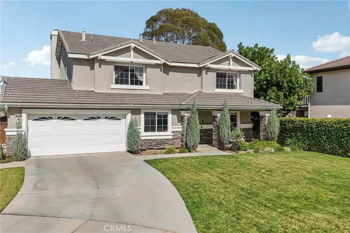 Pride of ownership shines with a wide driveway and strong curb appeal