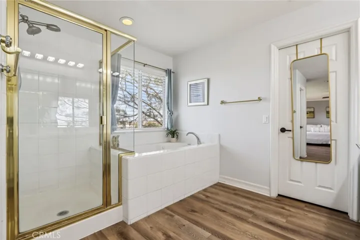 Primary bathroom featuring a walk-in shower and soaking tub providing both convenience and comfort