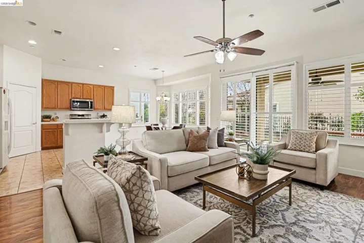 Living room with light wood-style flooring, a ceiling fan, and recessed lighting