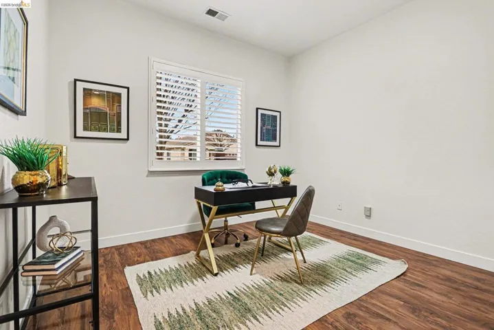 Office with baseboards and dark wood-type flooring