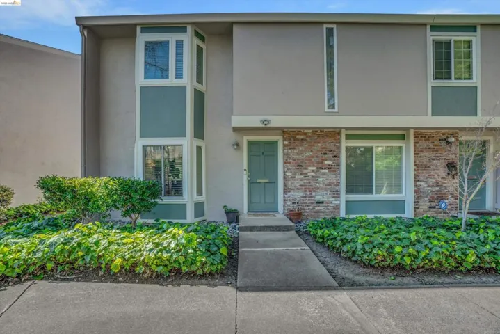 View of front of house featuring stucco siding and brick siding