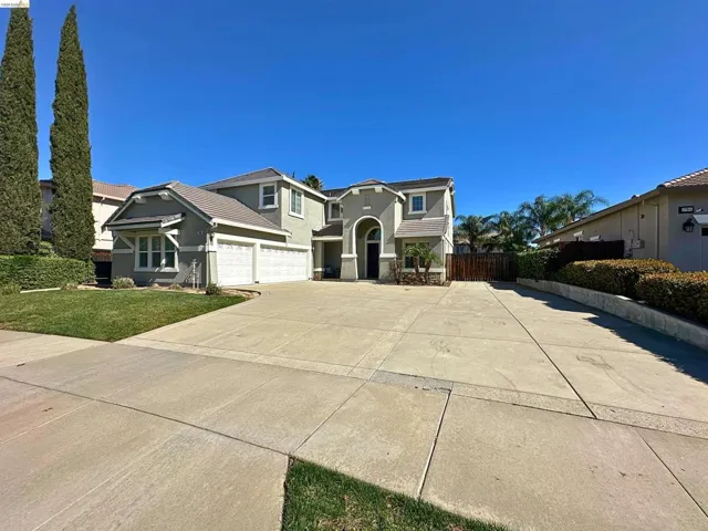 Craftsman-style home with stucco siding and concrete driveway