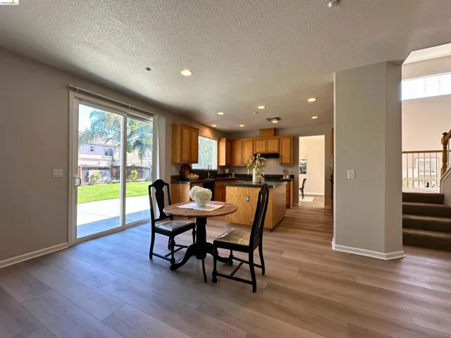 Dining space with recessed lighting, light wood-style floors, and a textured ceiling