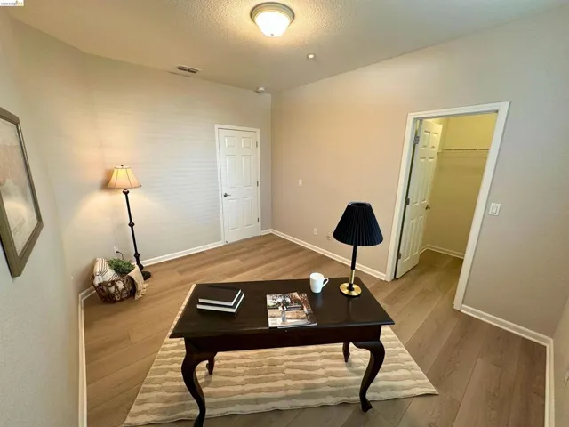 Office featuring light wood-style floors and a textured ceiling