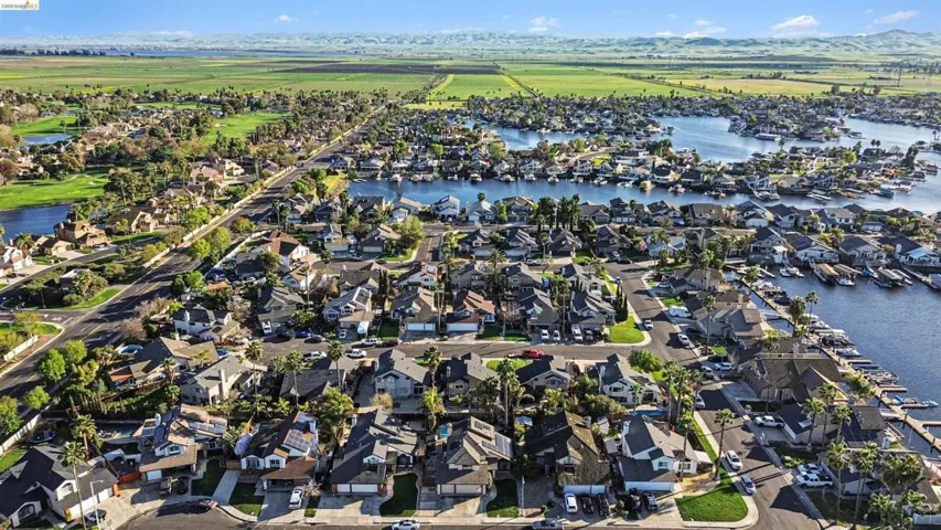 Aerial view of residential area featuring a large body of water