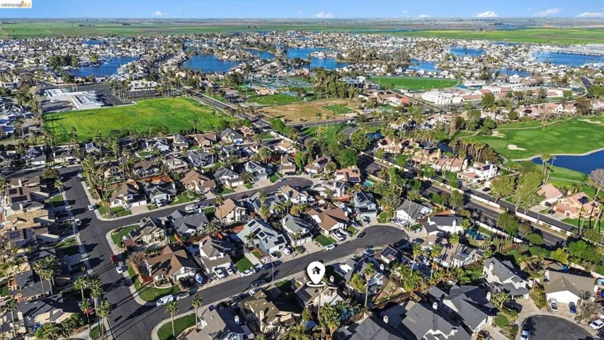 Aerial view of property and surrounding area with nearby suburban area